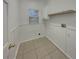 Convenient laundry room with built-in shelving and natural light at 148 Blue Stone Cir, Winter Garden, FL 34787