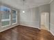 Bright living room with hardwood floors, large windows and modern lighting fixture at 148 Blue Stone Cir, Winter Garden, FL 34787