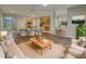 Spacious living room open to the kitchen, featuring wood floors, neutral walls, and modern decor at 148 Blue Stone Cir, Winter Garden, FL 34787