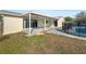 Spacious backyard with a covered patio, lush grass, and a fenced-in pool, perfect for outdoor enjoyment at 759 Little Wekiva Cir, Altamonte Springs, FL 32714