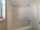 Shower and tub featuring all-white tile at 759 Little Wekiva Cir, Altamonte Springs, FL 32714