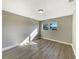 Sunny bedroom featuring neutral walls, hardwood floors, and a large window at 759 Little Wekiva Cir, Altamonte Springs, FL 32714