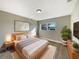 Well-lit main bedroom with a wooden bed frame, stylish décor, and hardwood floors at 759 Little Wekiva Cir, Altamonte Springs, FL 32714