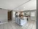 Open kitchen with white cabinets, stainless steel appliances, and a central island with granite countertops at 759 Little Wekiva Cir, Altamonte Springs, FL 32714