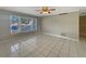 Bright living room featuring neutral walls, tile floors, a ceiling fan, and a large window at 759 Little Wekiva Cir, Altamonte Springs, FL 32714