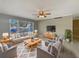 Bright living room featuring gray walls, tile floors, stylish furniture, and a ceiling fan at 759 Little Wekiva Cir, Altamonte Springs, FL 32714