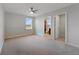 Spacious bedroom with a ceiling fan, window, and access to a bathroom and walk-in closet at 5692 Camilla St, St Cloud, FL 34771