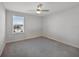 Empty bedroom with neutral carpet and paint, a window, and a ceiling fan at 5692 Camilla St, St Cloud, FL 34771