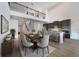Open concept dining room and kitchen with dark cabinets and a spacious island at 5692 Camilla St, St Cloud, FL 34771
