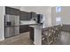 Beautiful kitchen features a large island, stainless steel appliances, and hardwood floors at 5692 Camilla St, St Cloud, FL 34771