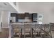 Kitchen island features bar stool seating, stainless appliances, and light countertops at 5692 Camilla St, St Cloud, FL 34771