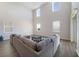 Bright living room boasts high ceilings and modern finishes, creating an open and airy space at 5692 Camilla St, St Cloud, FL 34771