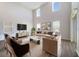 Bright living room with high ceilings, hardwood floors, and a large television at 5692 Camilla St, St Cloud, FL 34771