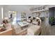 Bright living room with soaring ceilings, hardwood floors, and elegant furnishings at 5692 Camilla St, St Cloud, FL 34771