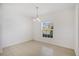 Bright dining area with neutral walls, tile floors, and natural light from a window at 410 Annabelle Way, Davenport, FL 33837