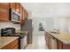 Modern kitchen featuring granite countertops and stainless steel appliances at 410 Annabelle Way, Davenport, FL 33837