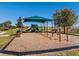 Community playground featuring swings, a slide, and a covered play area, ideal for children at 410 Annabelle Way, Davenport, FL 33837