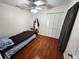 Cozy bedroom with hardwood floors, ceiling fan, and closet space at 106 Georgia Ave, Saint Cloud, FL 34769