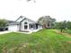 Side view of house shows a screened porch, attached garage, and well-manicured yard at 106 Georgia Ave, Saint Cloud, FL 34769