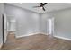 Bright bedroom with wood-look floors and access to other rooms at 1645 6Th Ave, Deland, FL 32724