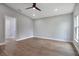 Spacious bedroom with wood-look floors and ceiling fan at 1645 6Th Ave, Deland, FL 32724