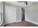 Bright bedroom with double door closet and wood-look floors at 1645 6Th Ave, Deland, FL 32724