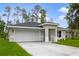 New construction home with white garage door and neatly landscaped yard at 1645 6Th Ave, Deland, FL 32724