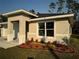 Newly constructed one-story home with a white garage door and landscaped front yard at 1645 6Th Ave, Deland, FL 32724