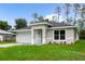 New construction home with white garage door and a well-manicured lawn at 1645 6Th Ave, Deland, FL 32724