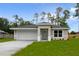 New construction home with white garage door and grassy front yard at 1645 6Th Ave, Deland, FL 32724