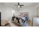 Bedroom featuring a plush bed with floral bedding, carpeted floors, ceiling fan, and a sleek dresser, creating a cozy retreat at 687 Campo Ln, Davenport, FL 33837