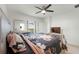 Bright bedroom featuring a ceiling fan, television, and a large window at 687 Campo Ln, Davenport, FL 33837