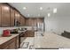Modern kitchen showcasing granite countertops, stainless steel appliances, a center island with seating, and ample cabinet space at 687 Campo Ln, Davenport, FL 33837