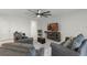 Bright living room with tile flooring, modern ceiling fan, comfortable seating, and a fireplace with mounted television at 687 Campo Ln, Davenport, FL 33837