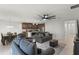 Open-concept living room and kitchen with tile flooring, modern ceiling fan, and comfortable seating arrangement in neutral tones at 687 Campo Ln, Davenport, FL 33837