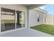Covered patio overlooking a grassy backyard and surrounded by white fencing at 687 Campo Ln, Davenport, FL 33837