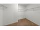 Empty walk-in closet with wire shelving and neutral carpet at 687 Campo Ln, Davenport, FL 33837