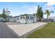 A mobile home featuring a concrete driveway and tasteful landscaping at 1366 Shipwreck Ln, Saint Cloud, FL 34771