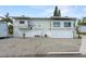 Exterior view of a well-maintained mobile home featuring clean gravel landscaping at 1366 Shipwreck Ln, Saint Cloud, FL 34771