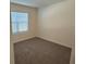 Bright bedroom featuring carpet floors and a large window at 2453 Shiprock Ct, Deltona, FL 32738