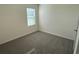 Well-lit bedroom featuring carpet flooring and a window at 2453 Shiprock Ct, Deltona, FL 32738