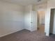 Well-lit bedroom with carpet flooring and access to another room at 2453 Shiprock Ct, Deltona, FL 32738