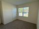 Spacious bedroom with carpet and large window at 2453 Shiprock Ct, Deltona, FL 32738