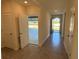 Open foyer showcasing tile floors and access to garage and backyard at 2453 Shiprock Ct, Deltona, FL 32738