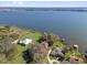 Wide aerial shot of a property with expansive lake frontage and private docks at 128 W Juliana Way, Auburndale, FL 33823