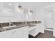 Bathroom featuring double sink vanity, granite countertops, and modern lighting fixtures at 128 W Juliana Way, Auburndale, FL 33823