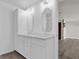 Modern bathroom with double vanity, granite countertop, white cabinets and wood-look vinyl flooring at 128 W Juliana Way, Auburndale, FL 33823