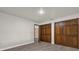 Bedroom featuring white walls, light gray wood flooring, and closet with wood doors at 128 W Juliana Way, Auburndale, FL 33823