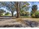 Charming home with a welcoming front porch, mature trees, and a well-manicured lawn at 128 W Juliana Way, Auburndale, FL 33823
