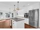 Modern kitchen with stainless steel appliances, granite countertops, and a large island with seating at 128 W Juliana Way, Auburndale, FL 33823